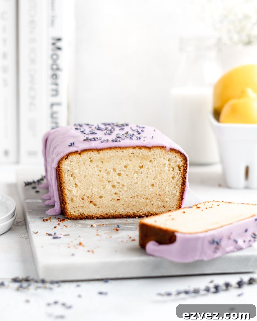 Fluffy and moist Lemon and lavender loaf cake is glazed in a purple coloured vanilla glaze