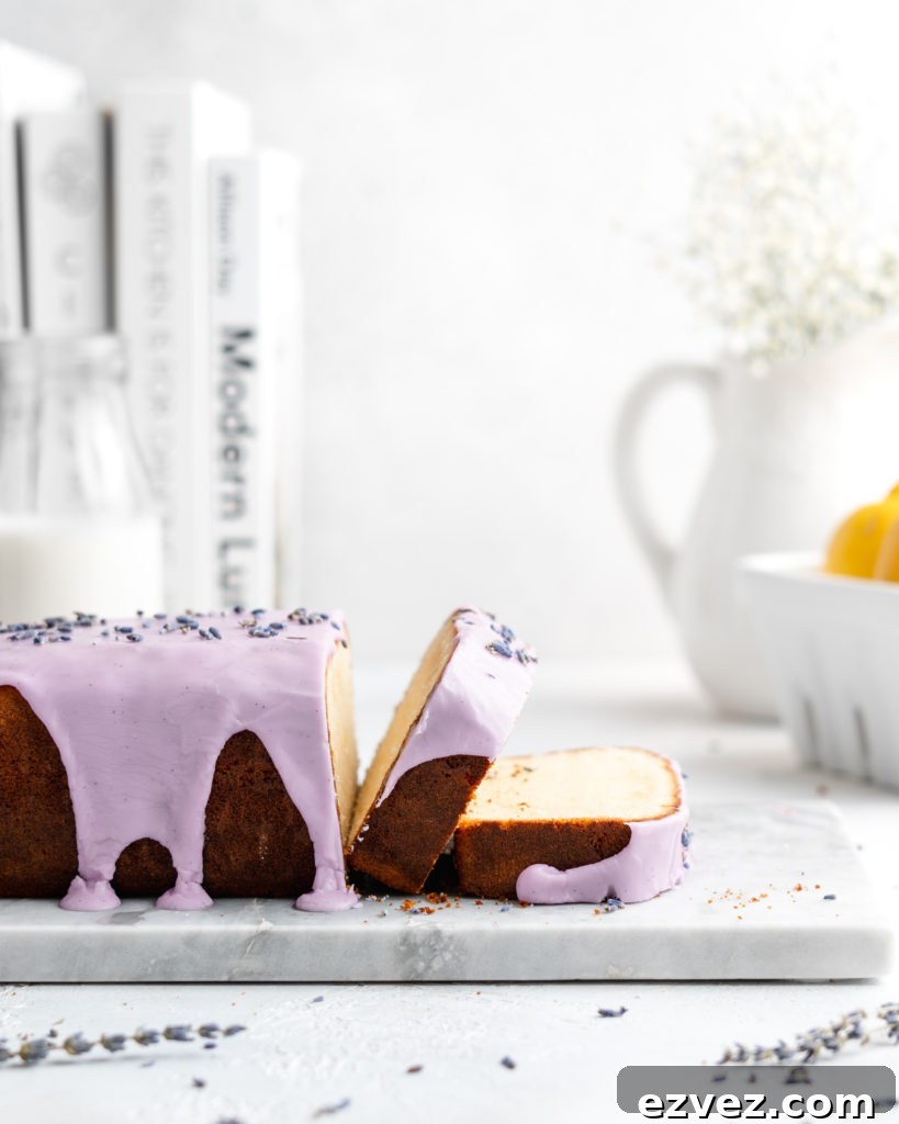 Fluffy and moist Lemon and lavender loaf cake is glazed in a purple coloured vanilla glaze