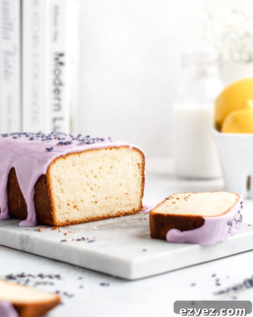 Fluffy and moist Lemon and lavender loaf cake is glazed in a purple coloured vanilla glaze