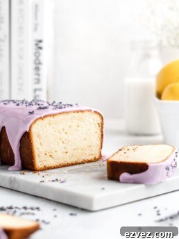 Fluffy and moist Lemon and lavender loaf cake is glazed in a purple coloured vanilla glaze
