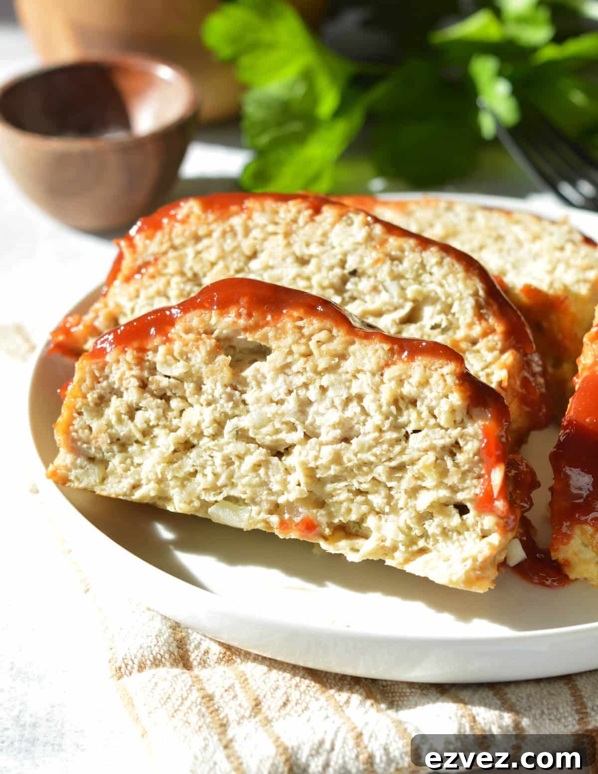 slices of chicken meatloaf on a plate. 