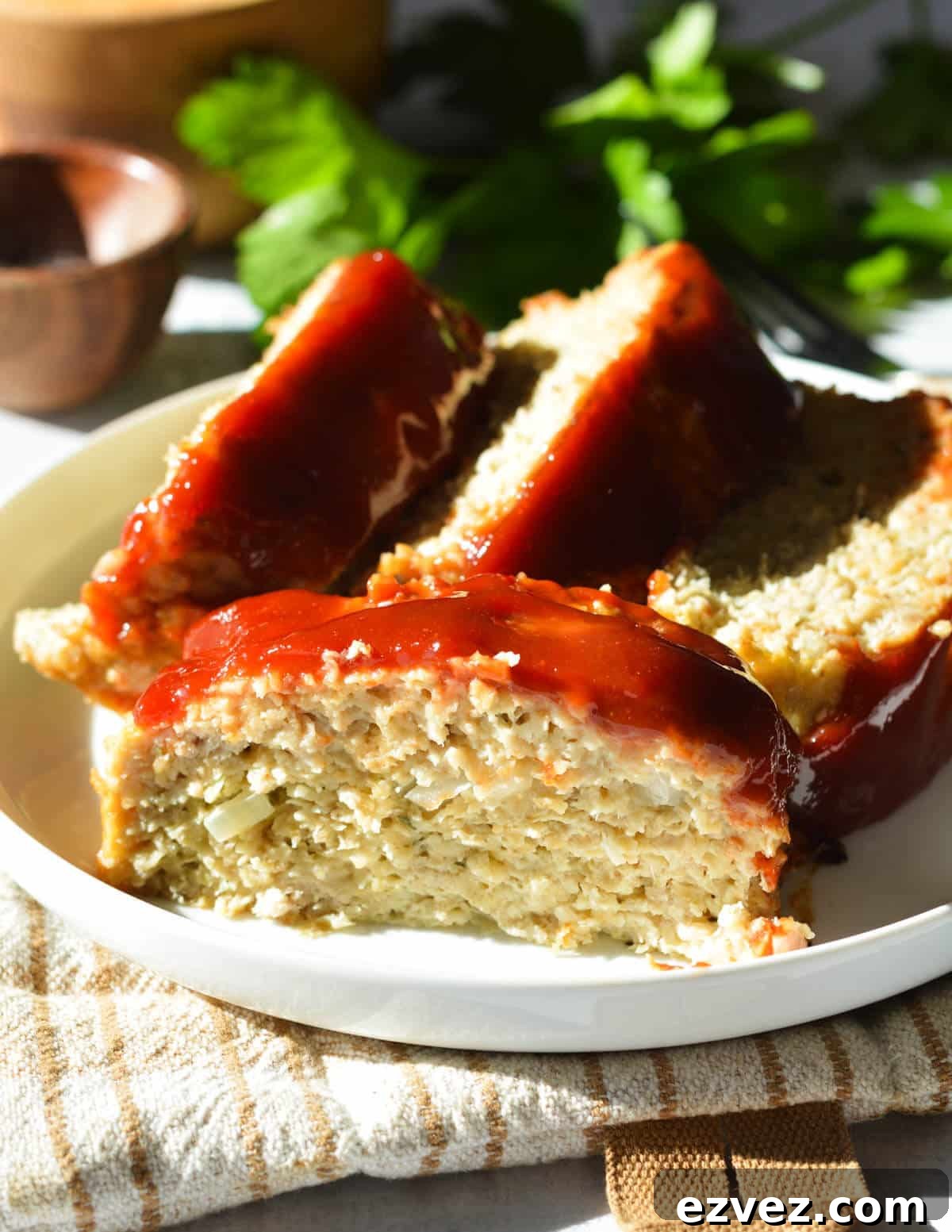 slices of chicken meatloaf on a plate. 