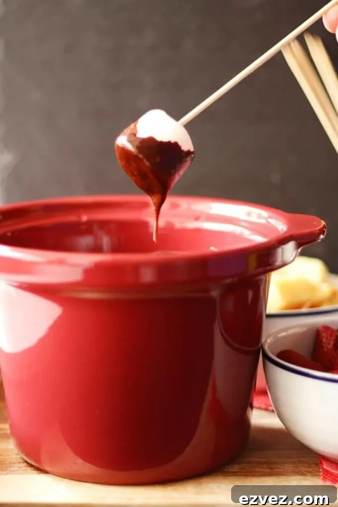 marshmallow dipped into chocolate fondue