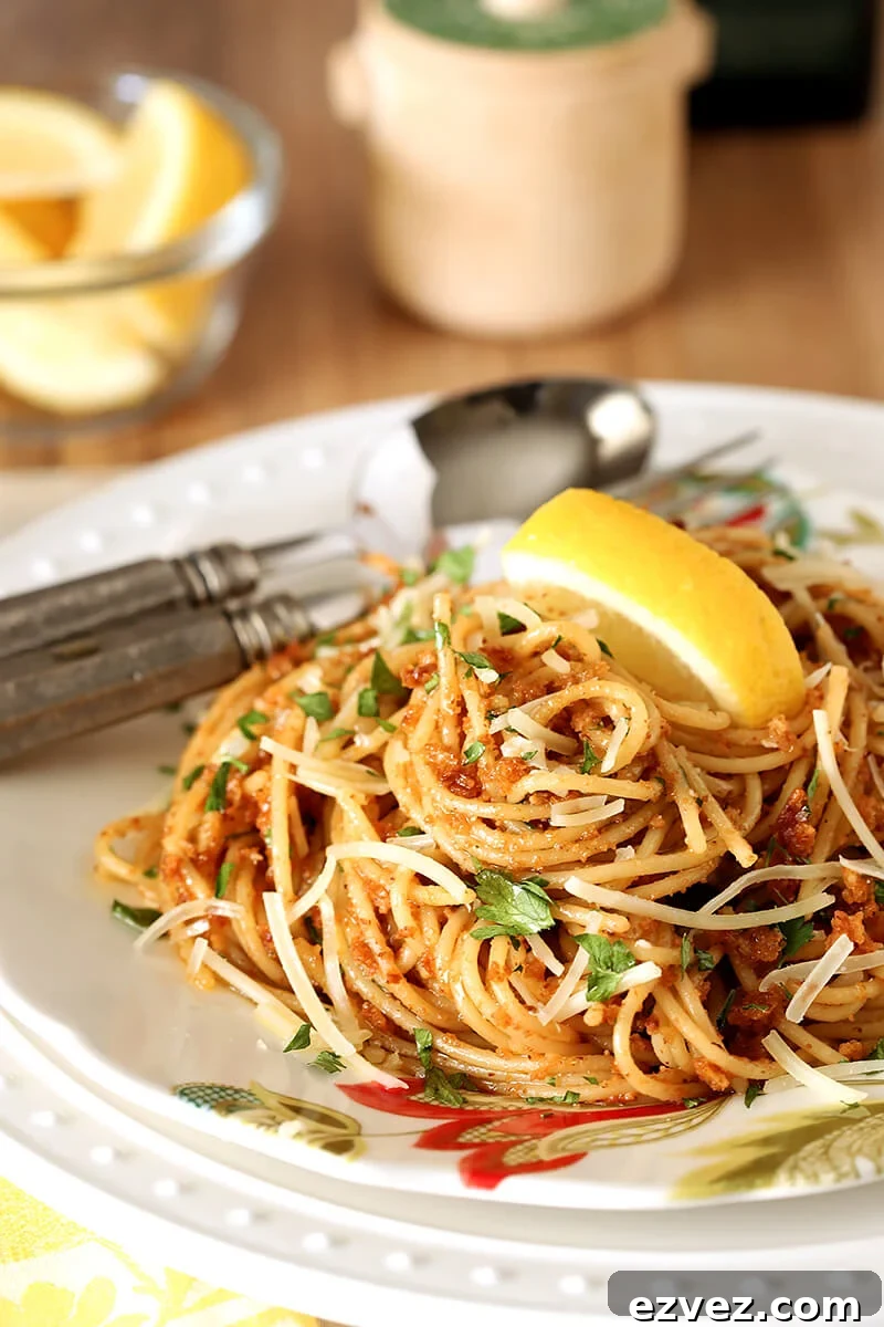 Plate of Pasta with Sun-Dried Tomato and Roasted Almond Pesto with a Lemon Garnish