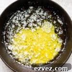 A small cast iron skillet with melted, smoked butter inside.