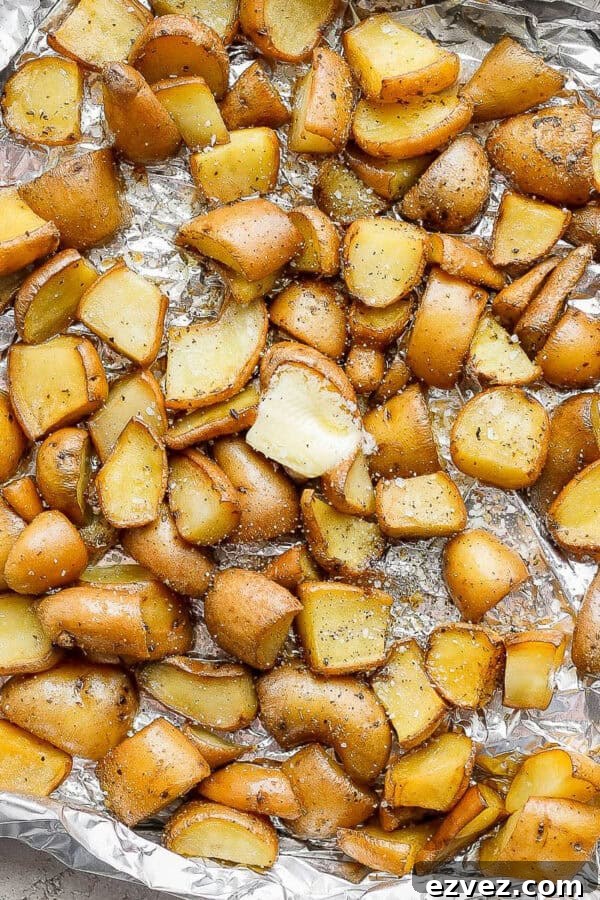 Smoked potatoes on an aluminum foil pan after being smoked.