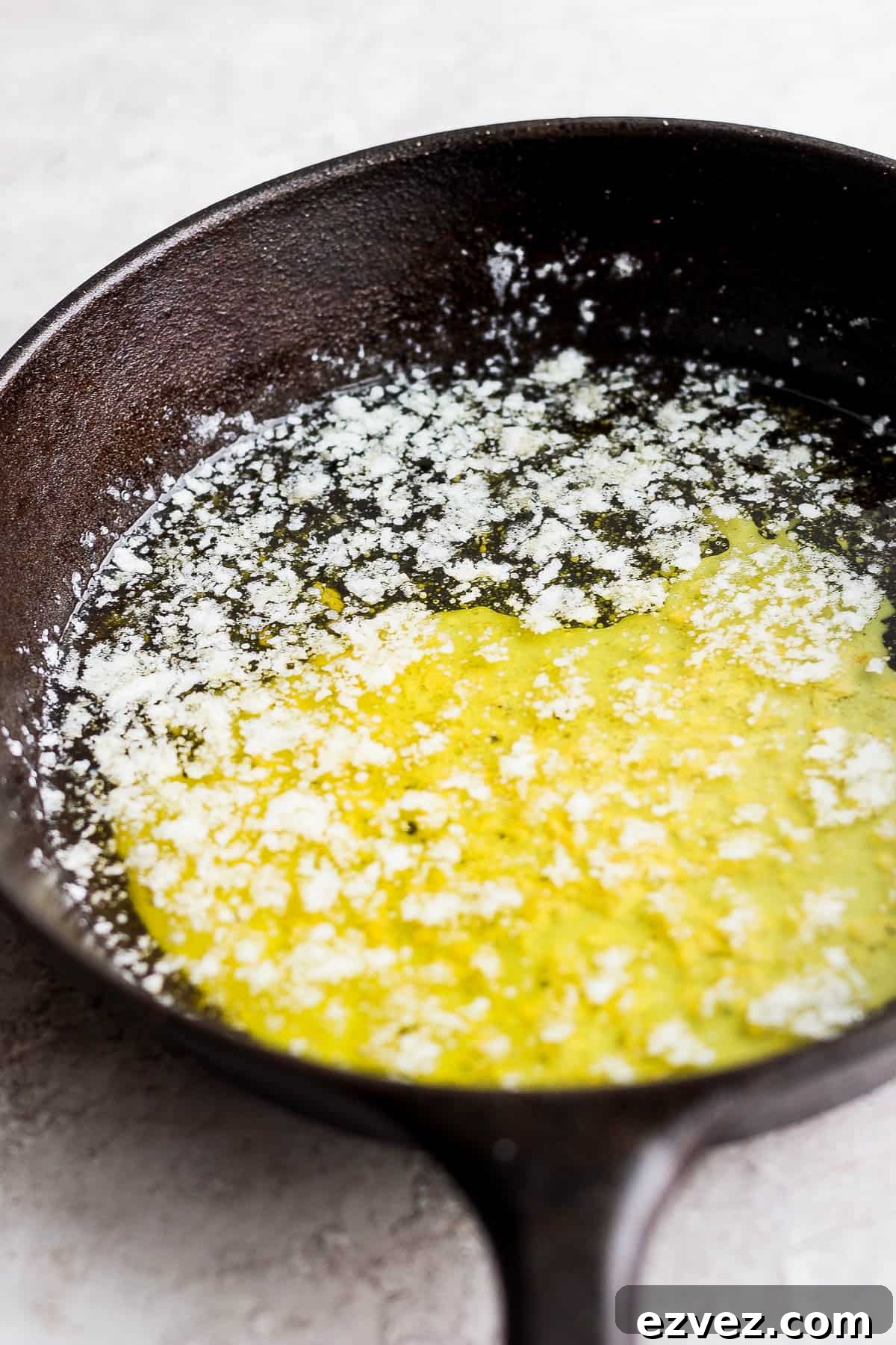 Fully melted smoked butter in a cast iron skillet.