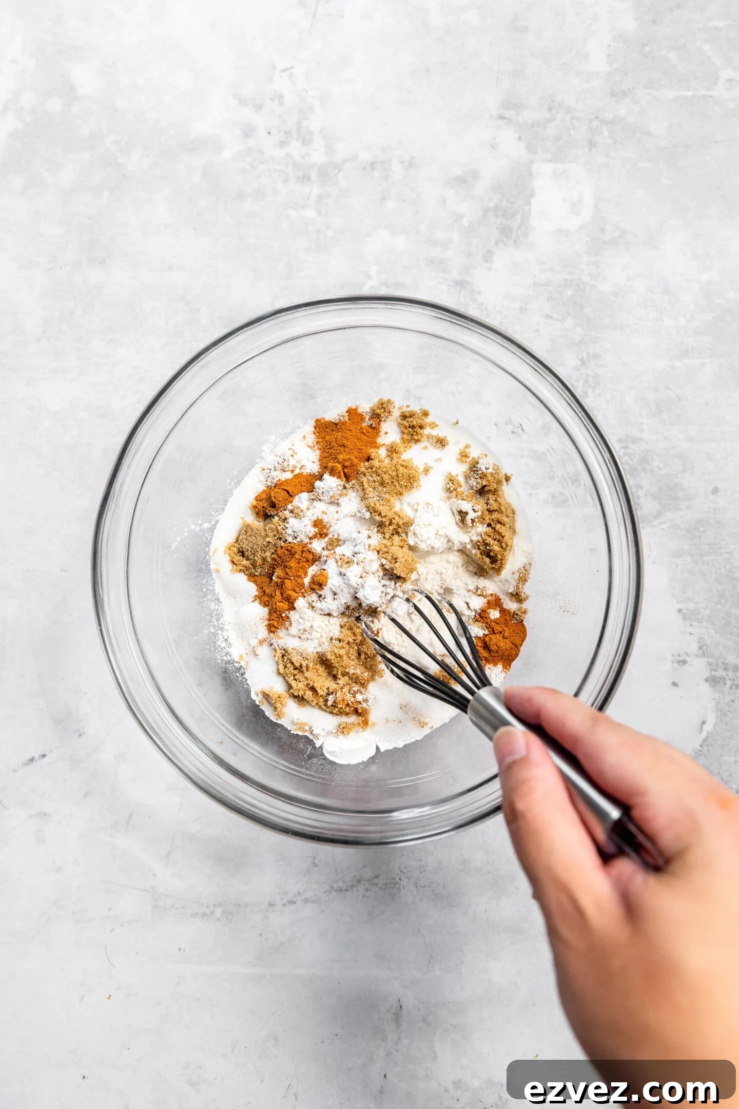 Dry ingredients being whisked together in a mixing bowl