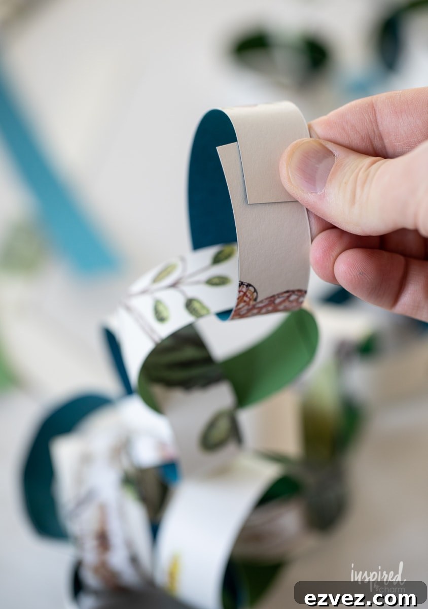 DIY Christmas Paper Chains from Wallpaper Rolls: Festive Holiday Decor 12 making a paper chain.