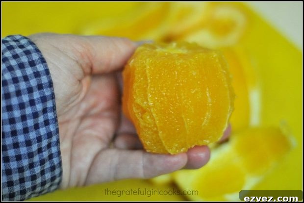 Sectioning a whole peeled orange for slices to use in Southwestern cobb salad.