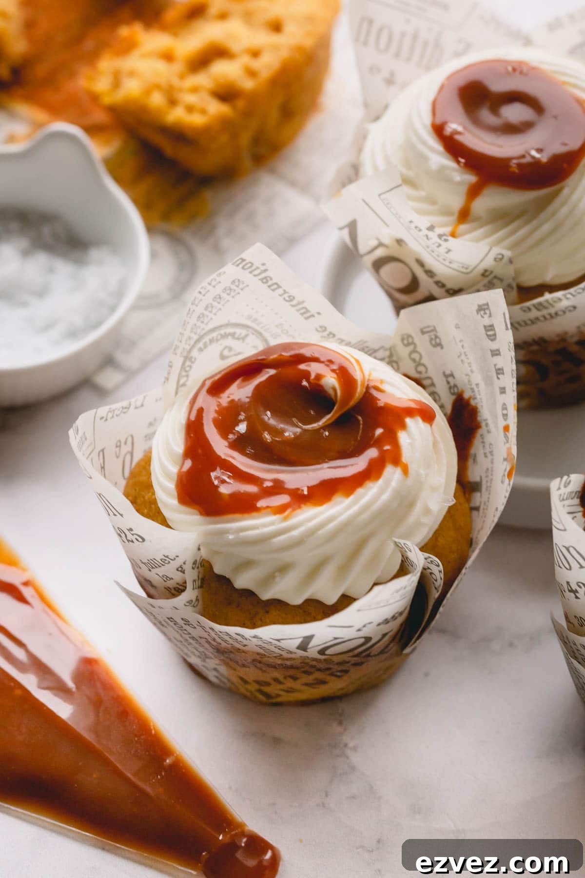Pumpkin cupcake topped with cream cheese frosting and salted caramel.
