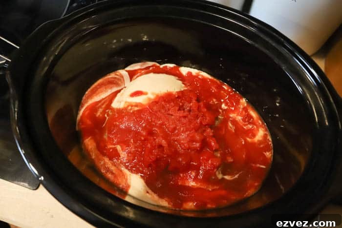 Creamy Tomato Chicken Spaghetti Made in a Slow Cooker 4 adding sauce to chicken