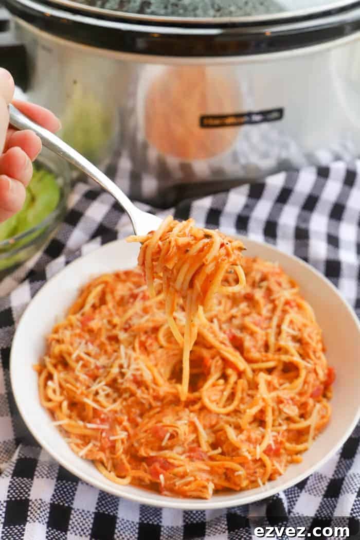 Creamy Tomato Chicken Spaghetti Made in a Slow Cooker 6 Slow Cooker Creamy Tomato Chicken Spaghetti on a fork