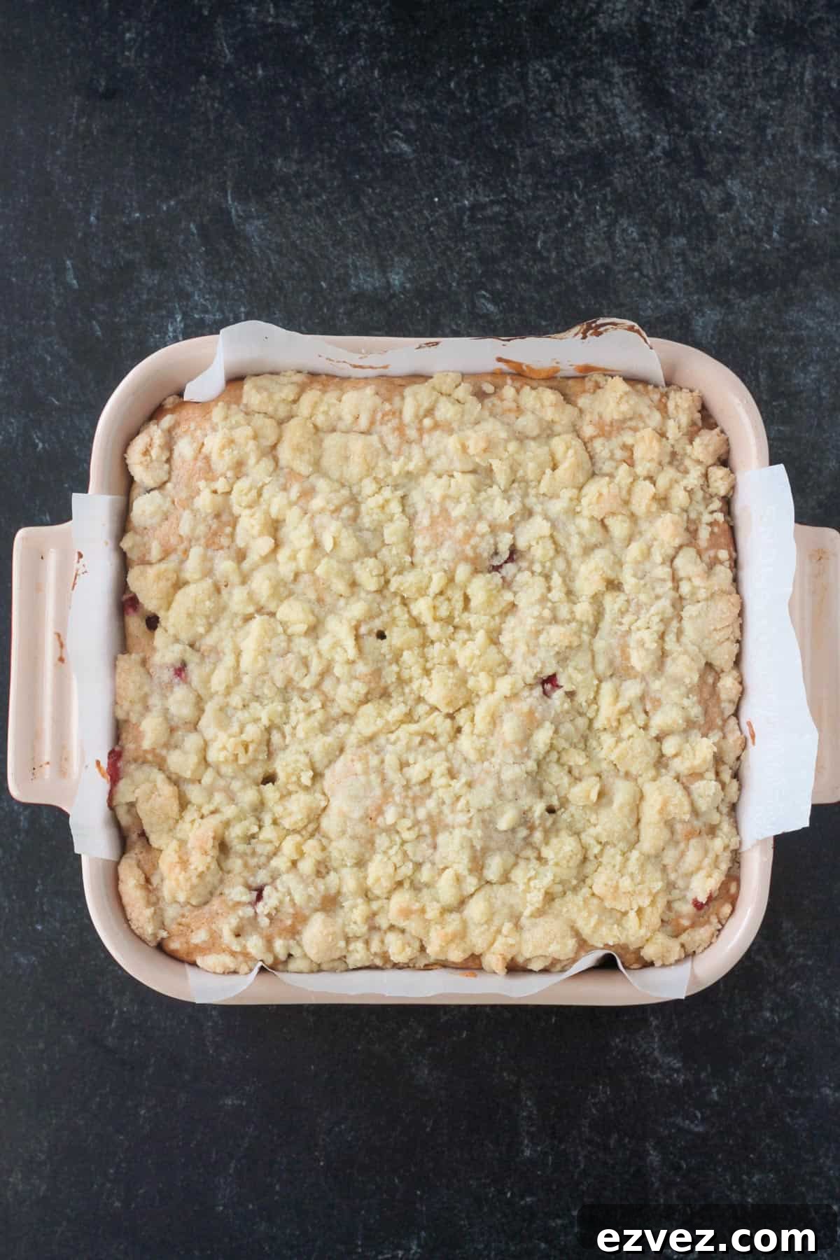 Orange cranberry cake with streusel topping in a square pan.