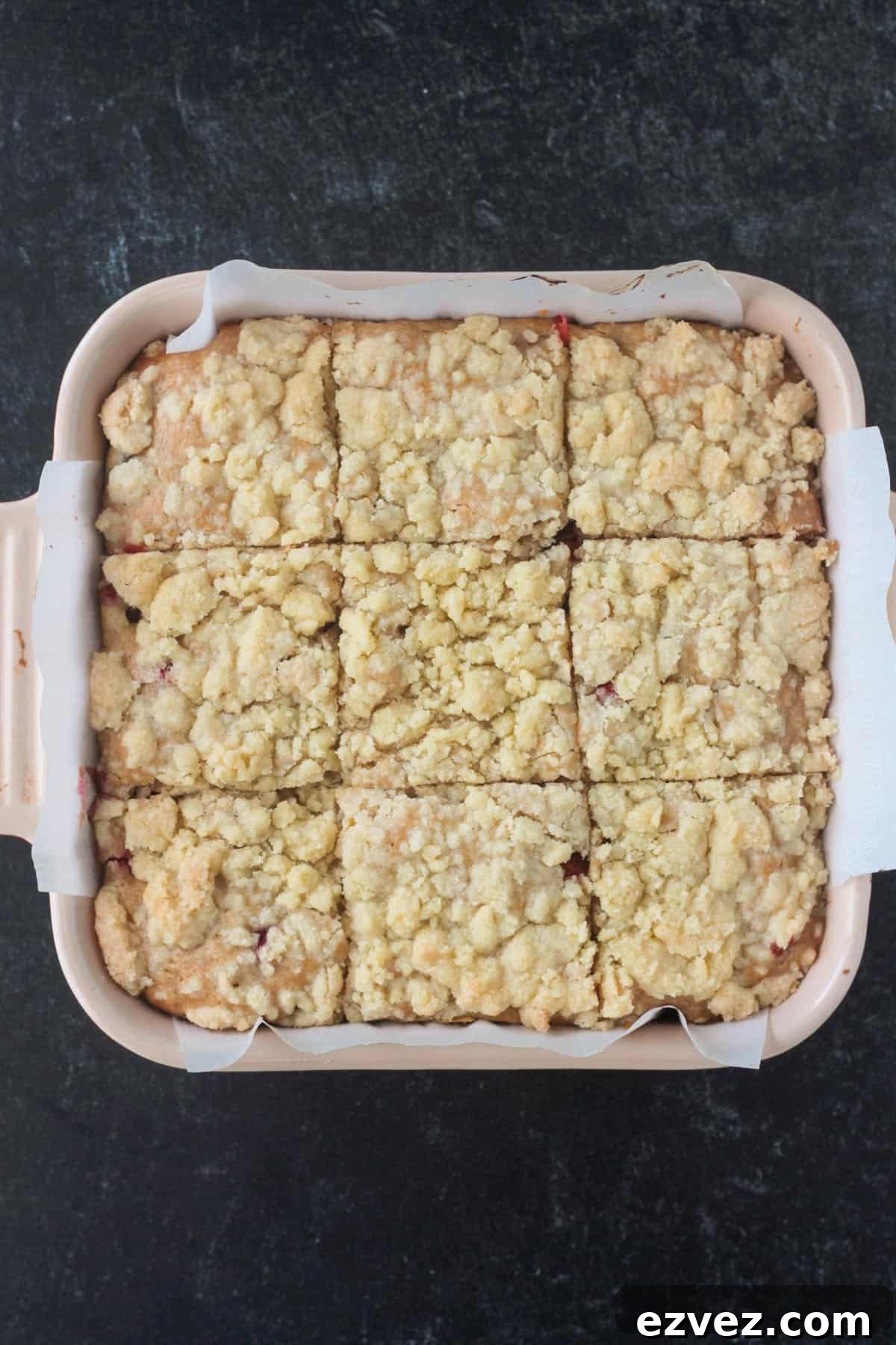 Baked cake cut into 9 equal square slices.