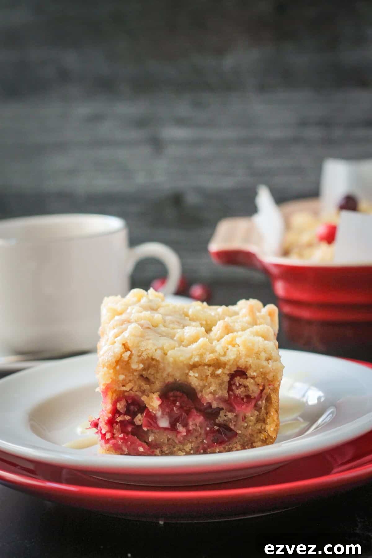 Slice of cranberry coffee cake on a plate.