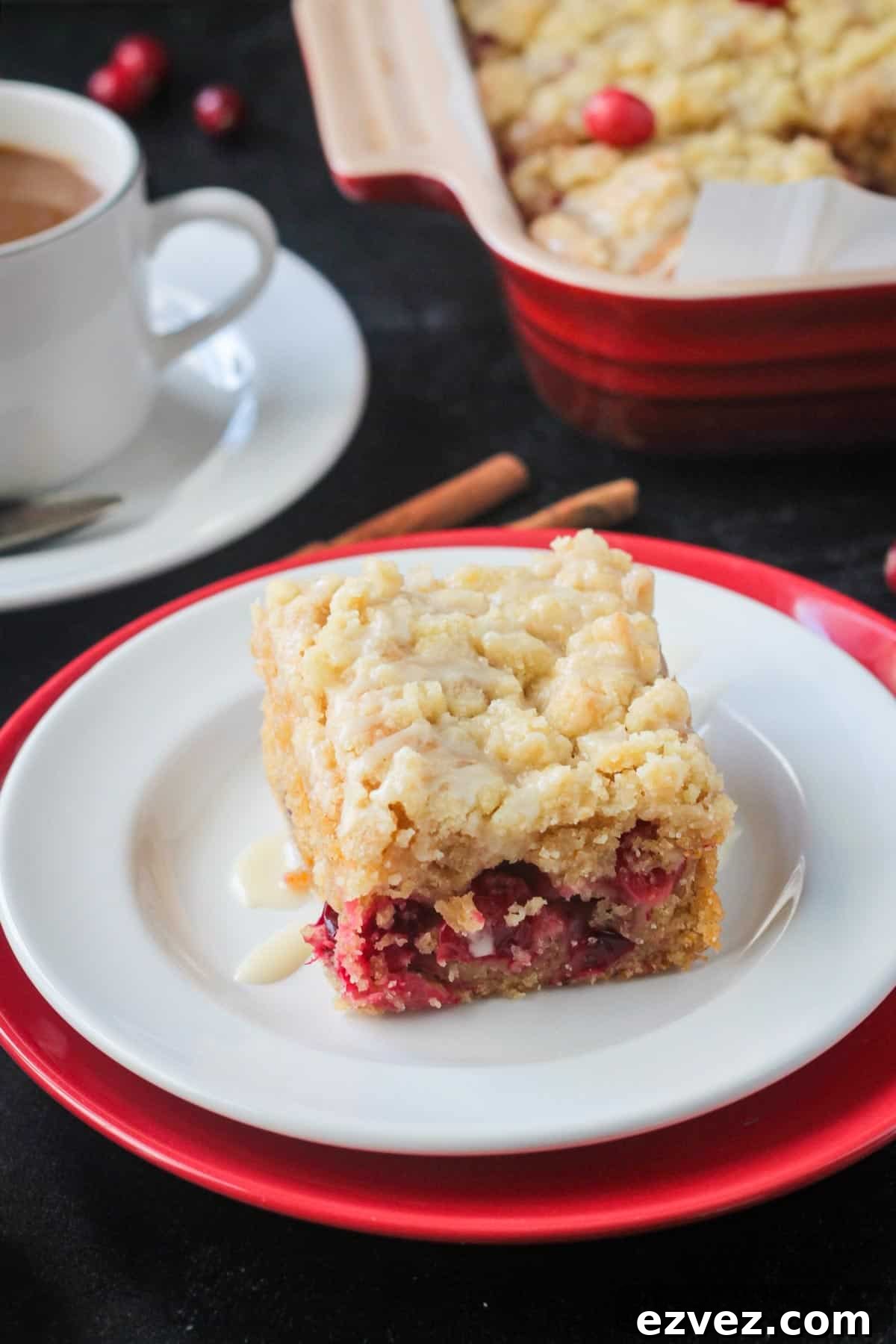 Slice of vegan orange cranberry cake on a plate.