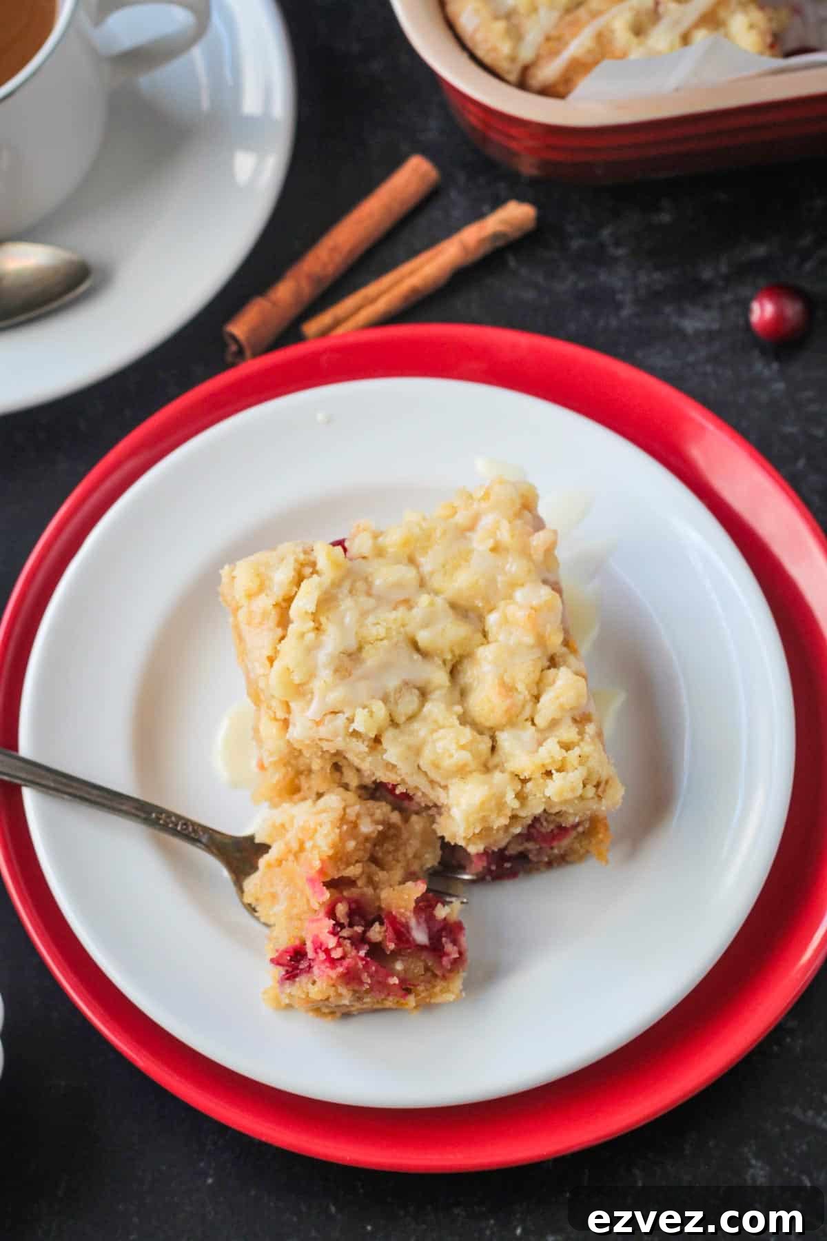 Slice of cake on a plate with a bite of cake on a fork.