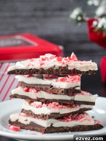 Stack of five pieces of vegan peppermint bark.