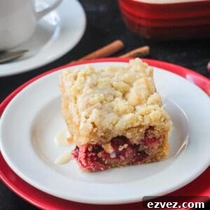 Slice of vegan orange cranberry cake on a plate.