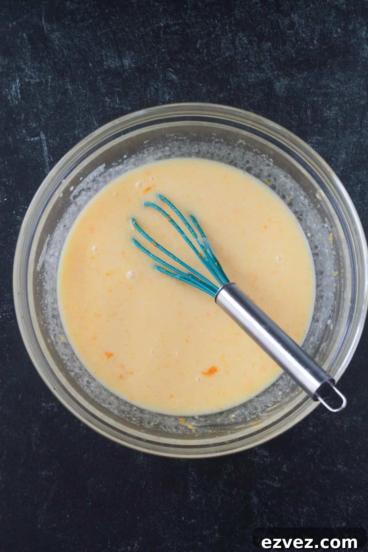 Wet ingredients whisked together in a mixing bowl.
