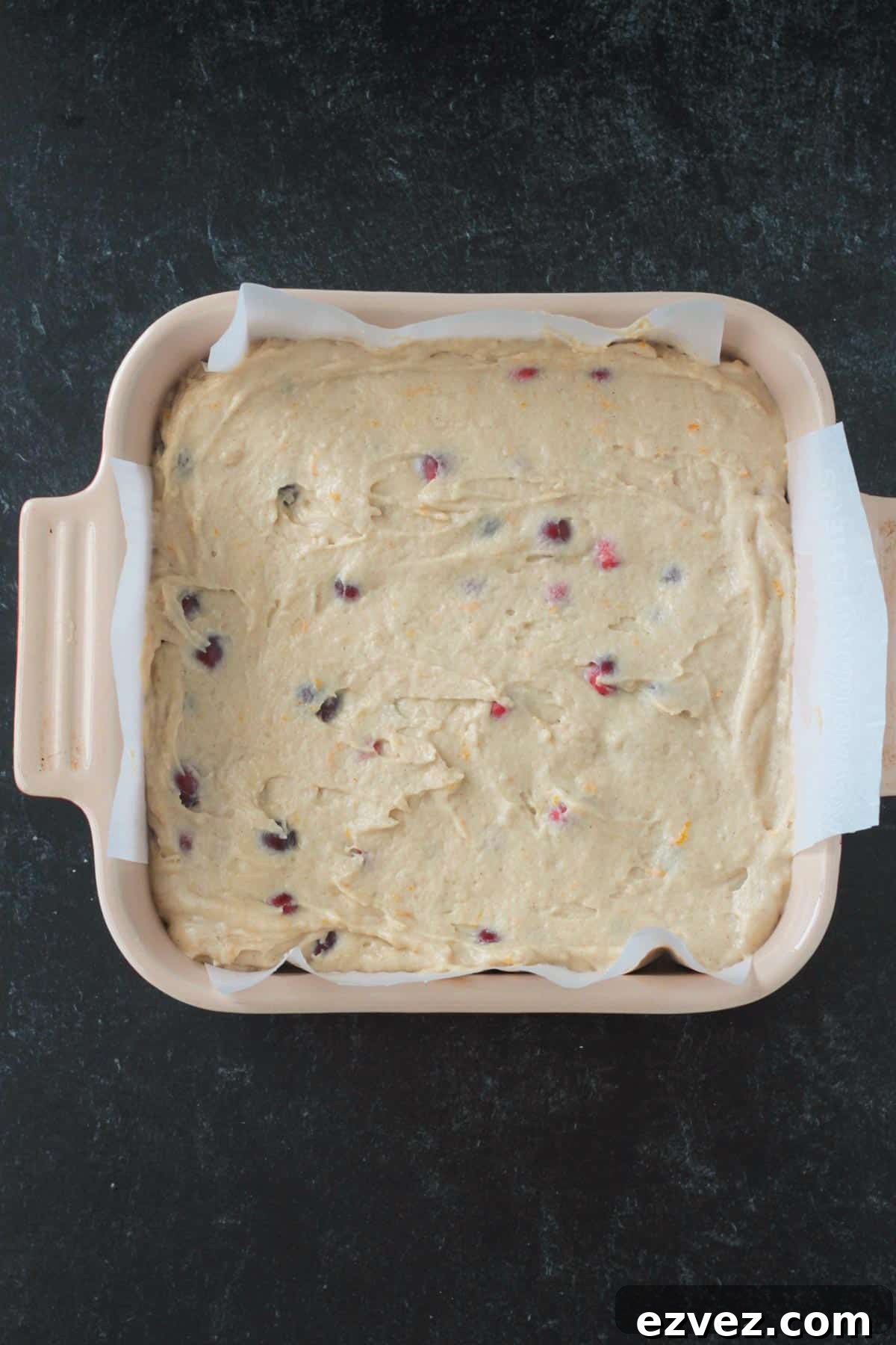 Batter in parchment lined square baking dish.