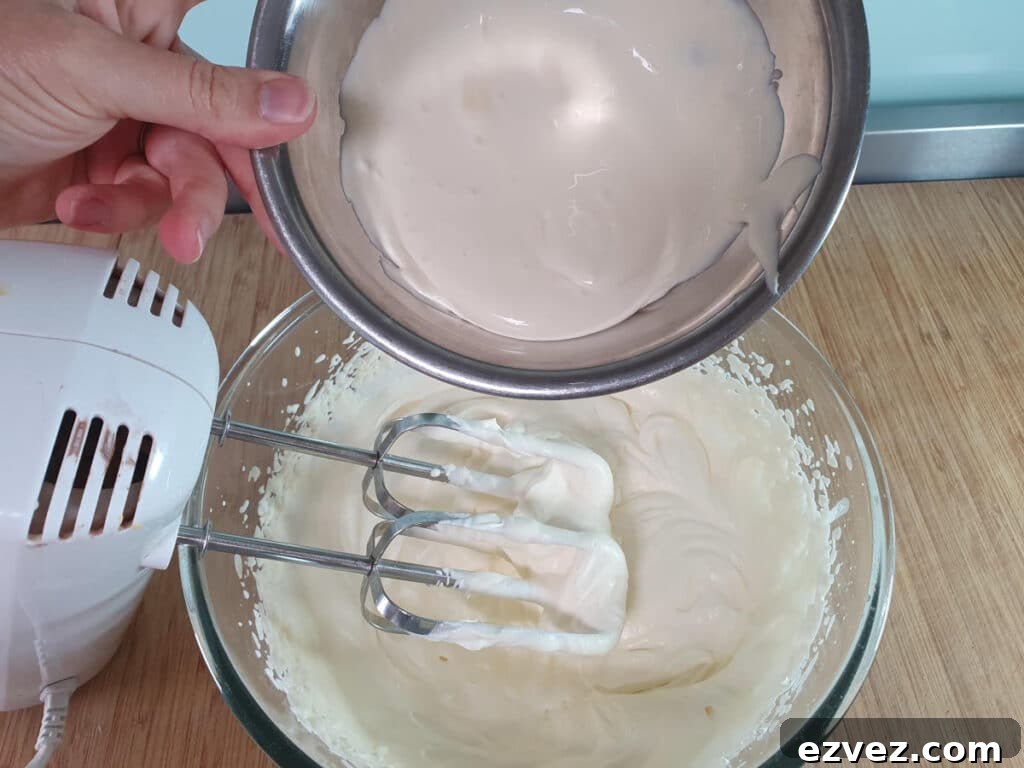 adding sour cream to whipped cream.