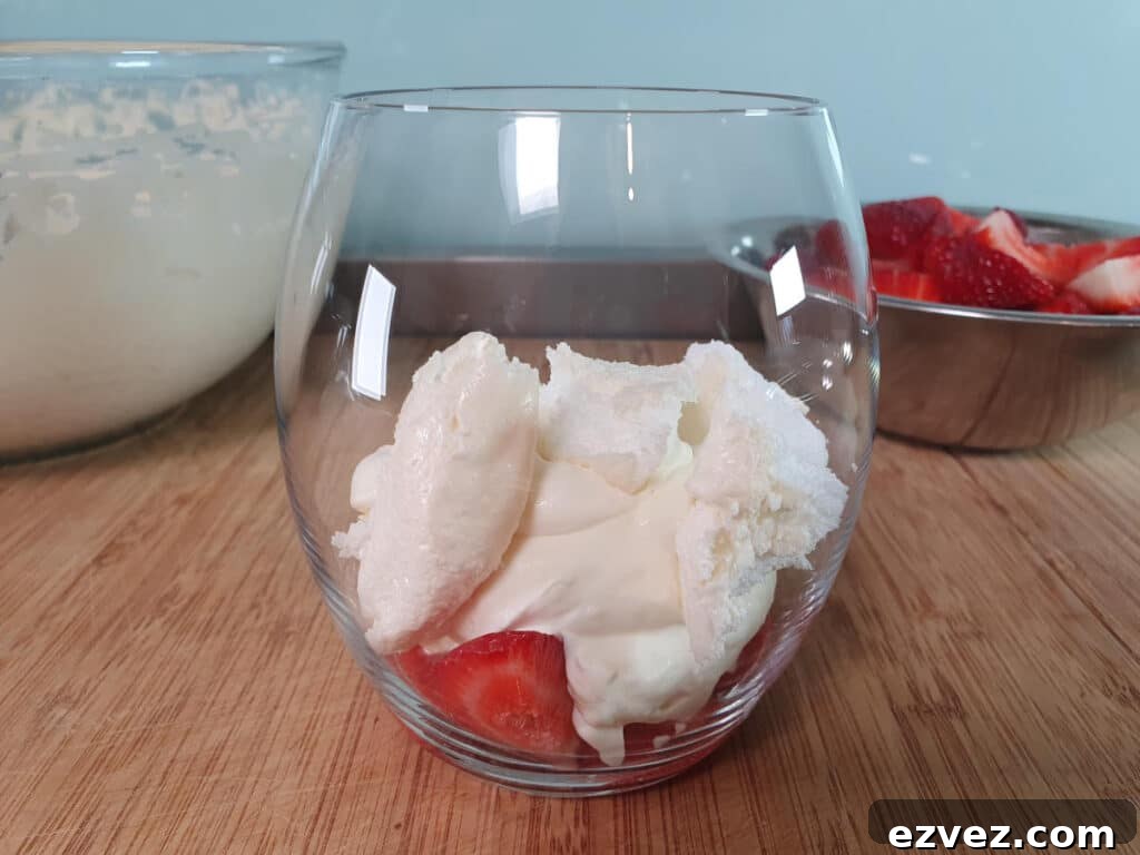 adding first layer cream mix and broken up meringues.