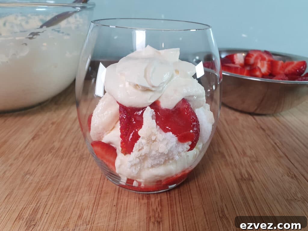 adding second layer of strawberries, strawberry sauce and cream.