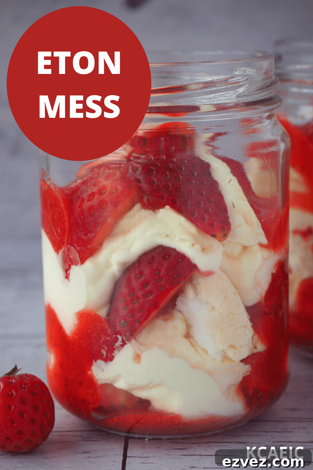 Two jars of Eton mess with fresh strawberries on the side with text overlay, Eton mess, KCAEIC.