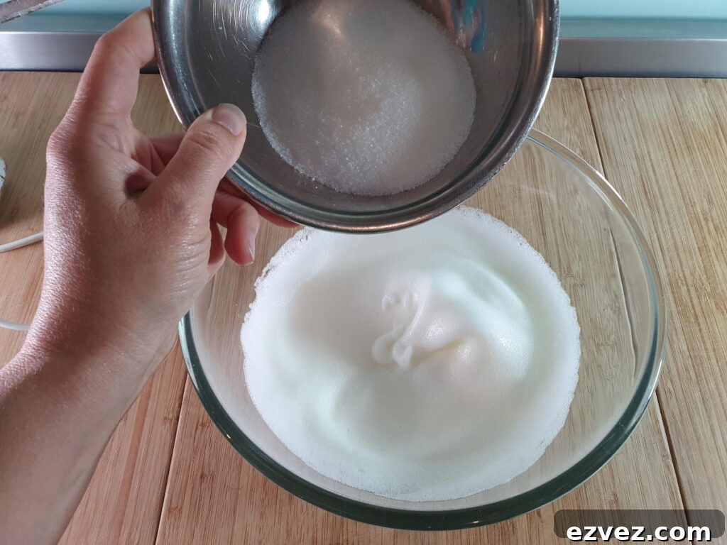 adding sugar to whipped egg whites.
