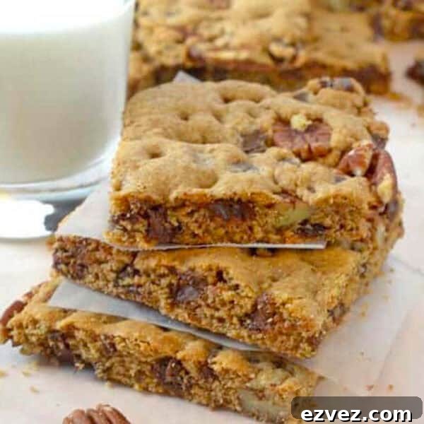 Chewy Caramel Apple Bars with Cinnamon Streusel 9 A stack of dessert bars with a glass of milk.