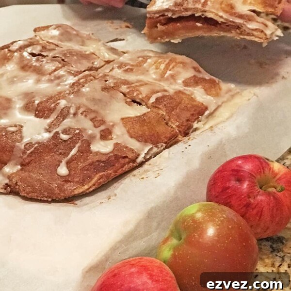 Chewy Caramel Apple Bars with Cinnamon Streusel 10 Cut apple bars on parchment with apples