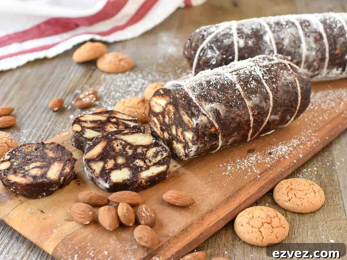 Two  chocolate logs that look like salami with few slices cut.