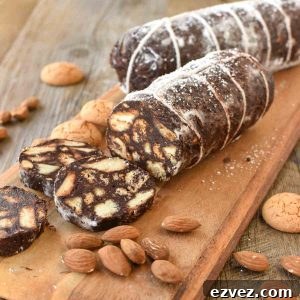 two chocolate salami on wooden board with three slices cut