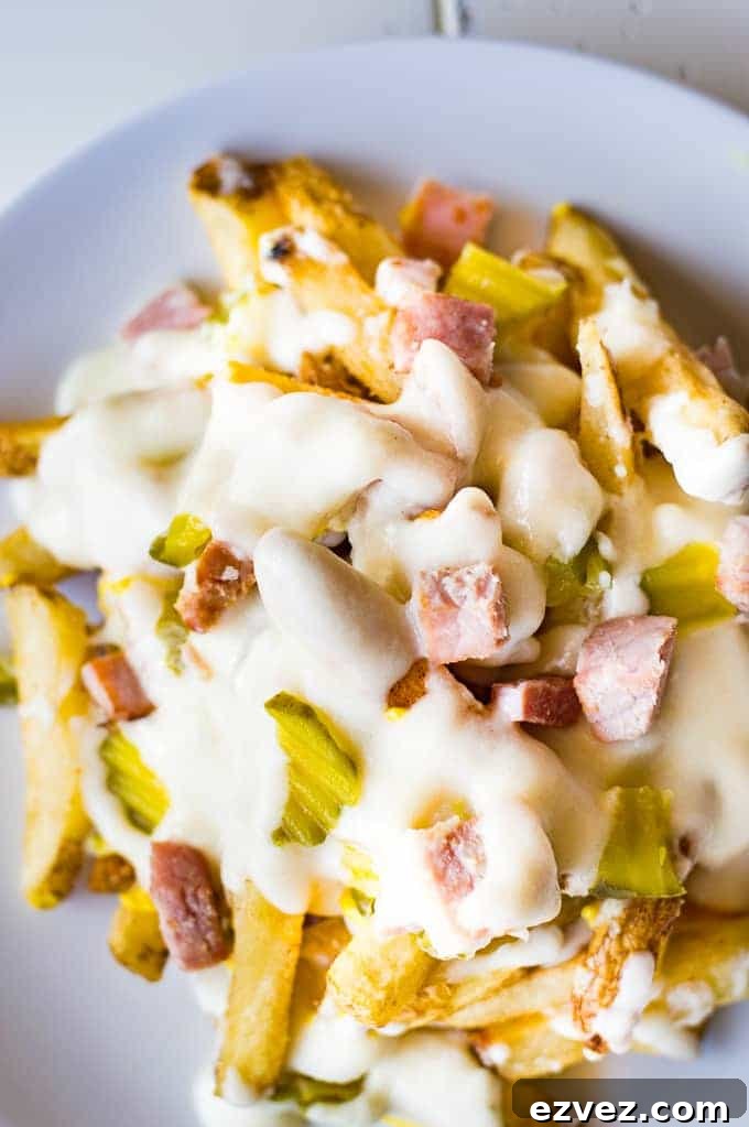 Crispy french fries loaded with all the flavors of a Cuban sandwich and topped with a creamy swiss cheese sauce! The ULTIMATE appetizer or snack recipe! A definite crowd pleaser!