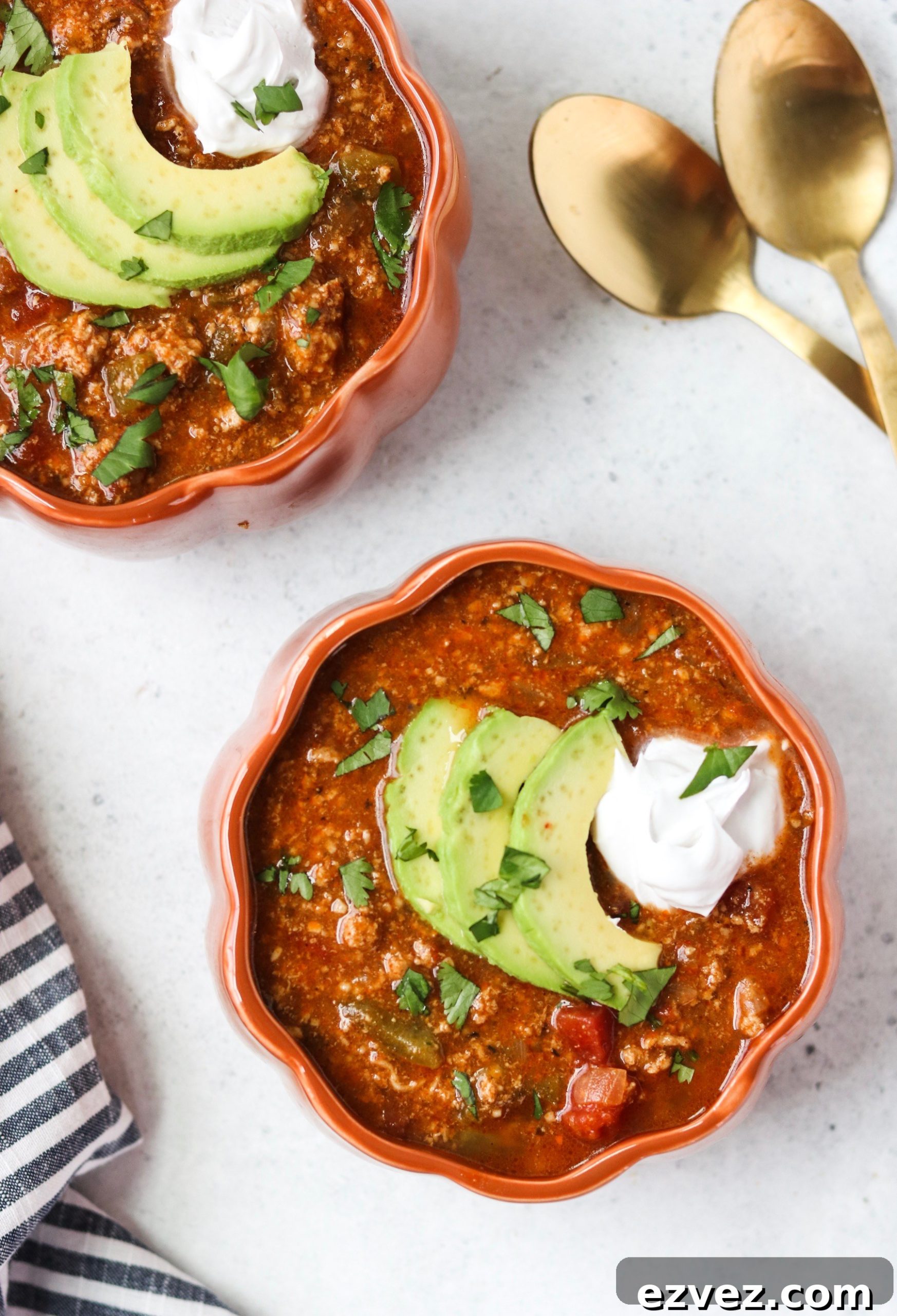 Bowl of pumpkin turkey chili with toppings