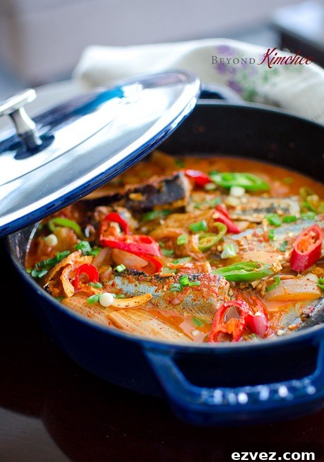 Kimchi Jjigae is made with canned mackerel pike fish in a blue pot.