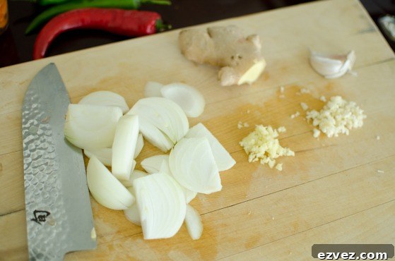 Thinly sliced onion, garlic, and ginger is prepped for making a Korean dish.