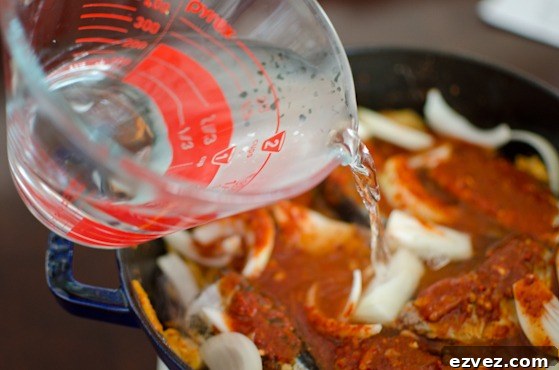 Pour water to a pot with kimchi and mackerel pike