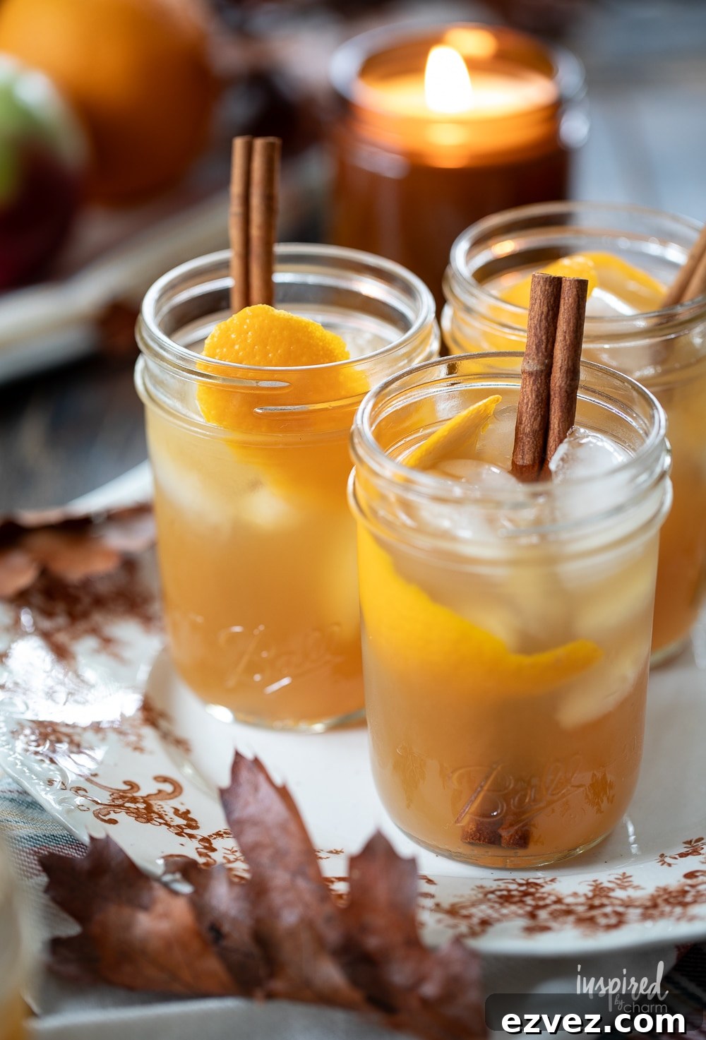 apple cider whiskey sour cocktails served in jars on a plate.