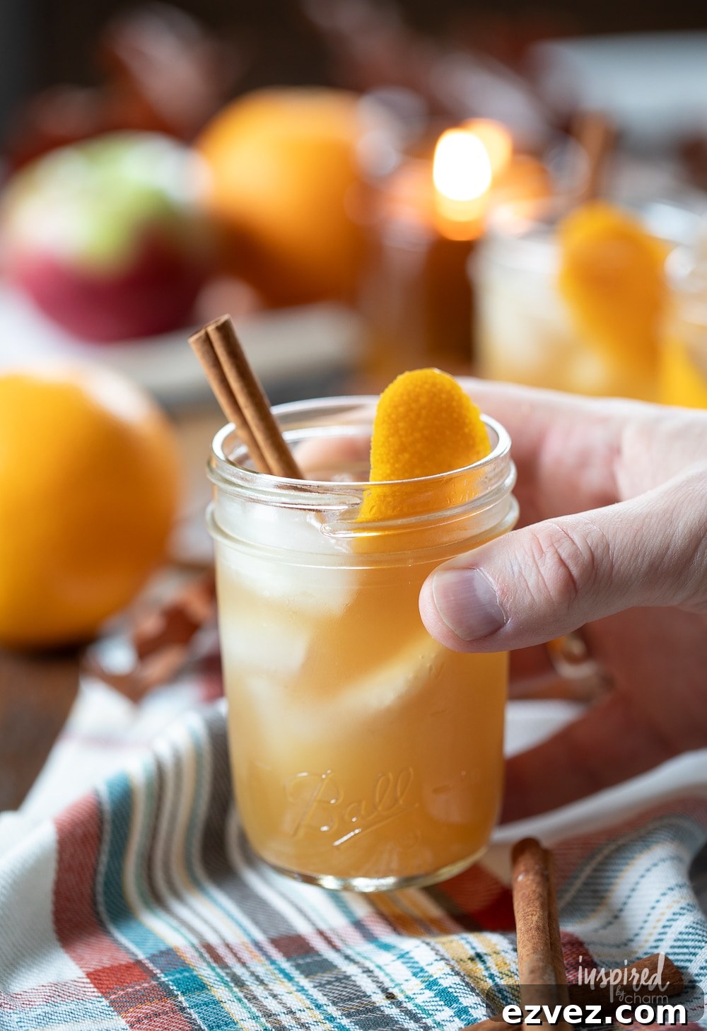 hand holding apple cider whiskey cocktail. 