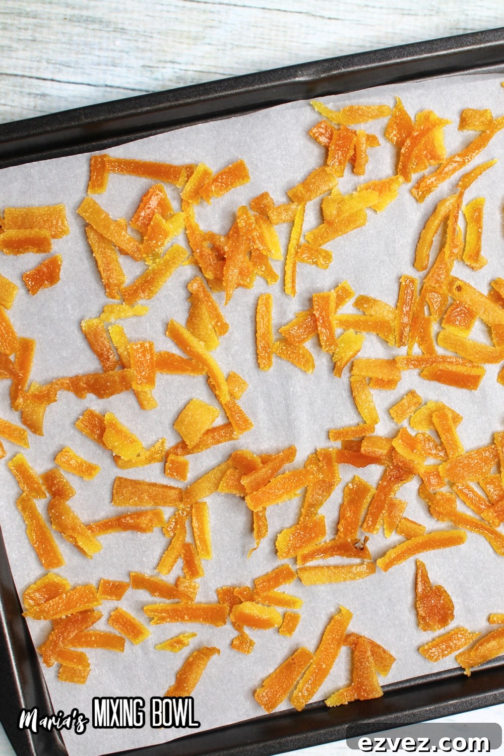 orange peels on a parchment lined baking sheet