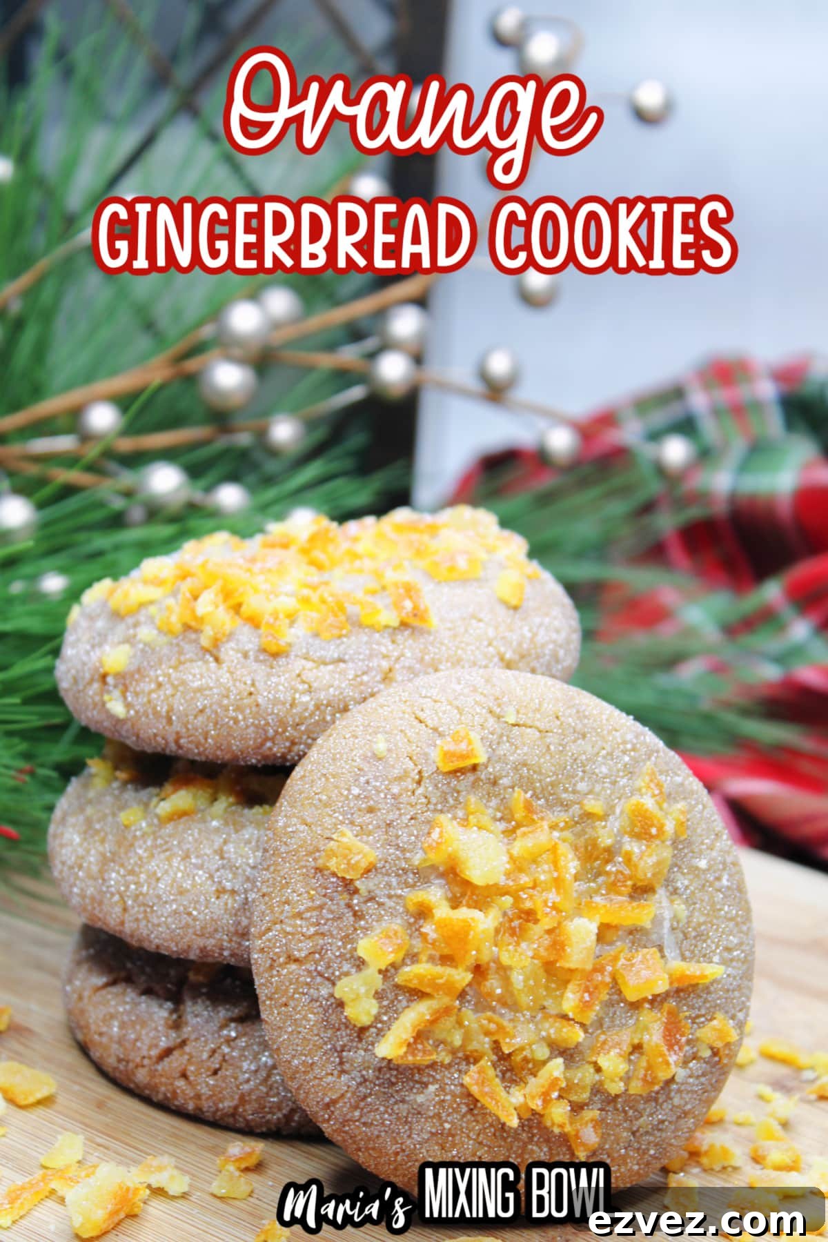 stack of orange gingerbread cookies on a wooden cutting board with the name in text for pinterest