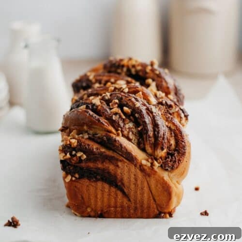 A baked nutella babka on parchment paper.