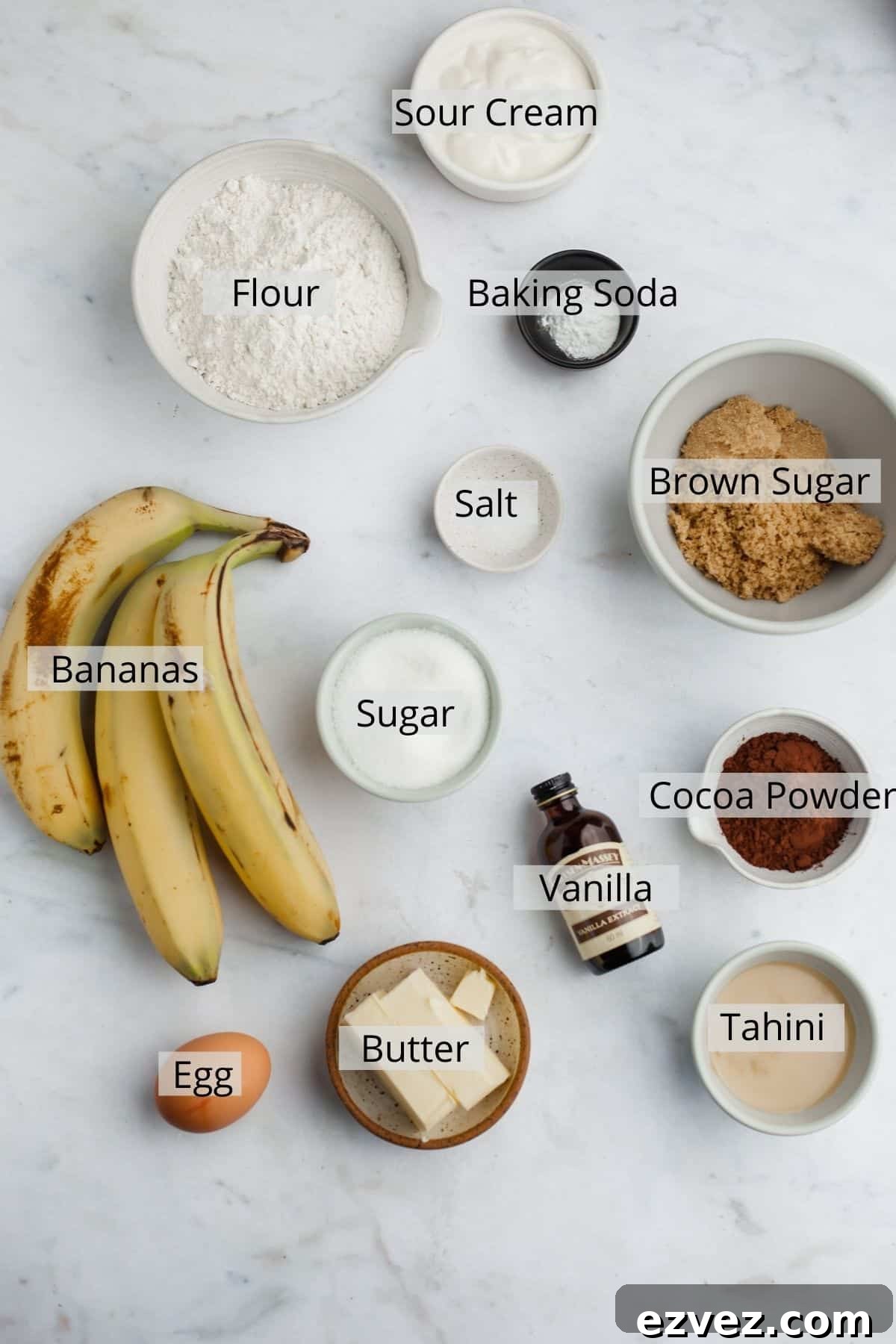 all the ingredients for tahini chocolate banana bread weighed out into small bowls.