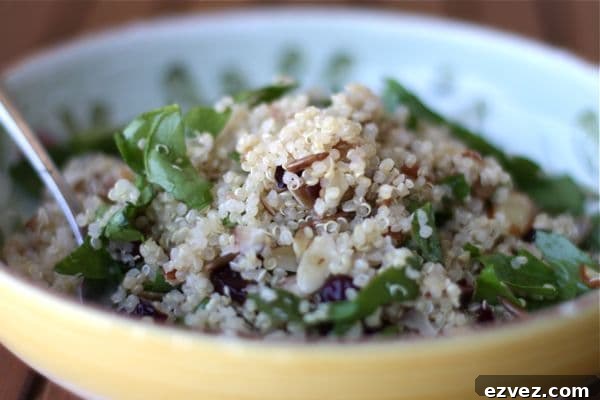 bowl with quinoa, spinach, almonds, sunflower seeds, and cranberries