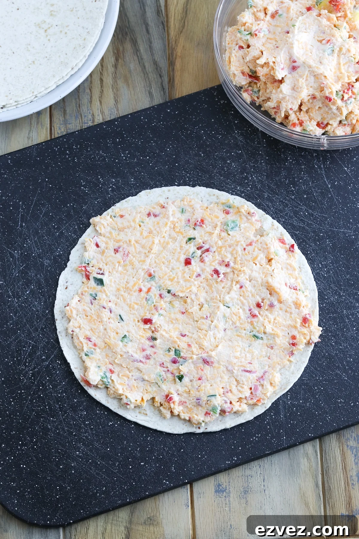 wrap with pimento cheese spread on it laying flat on cutting board