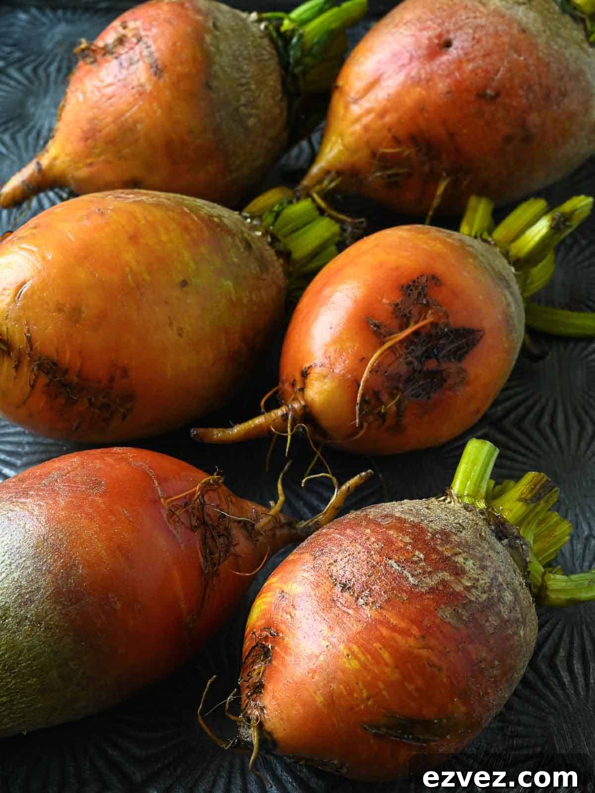 Washed yellow beets on a metal tray.