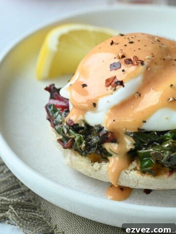 Close-up of eggs Florentine with tomato hollandaise.